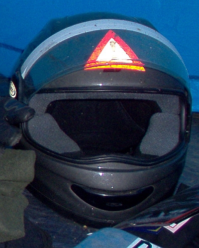 My grey helmet covered in hazard sign stickers