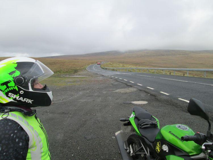 Sharon looks out across misty moors and a lonely road on The Black Mountain Pass