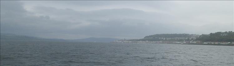 The clyde estuary, massive broad stretch of water between very wet and misty mountains