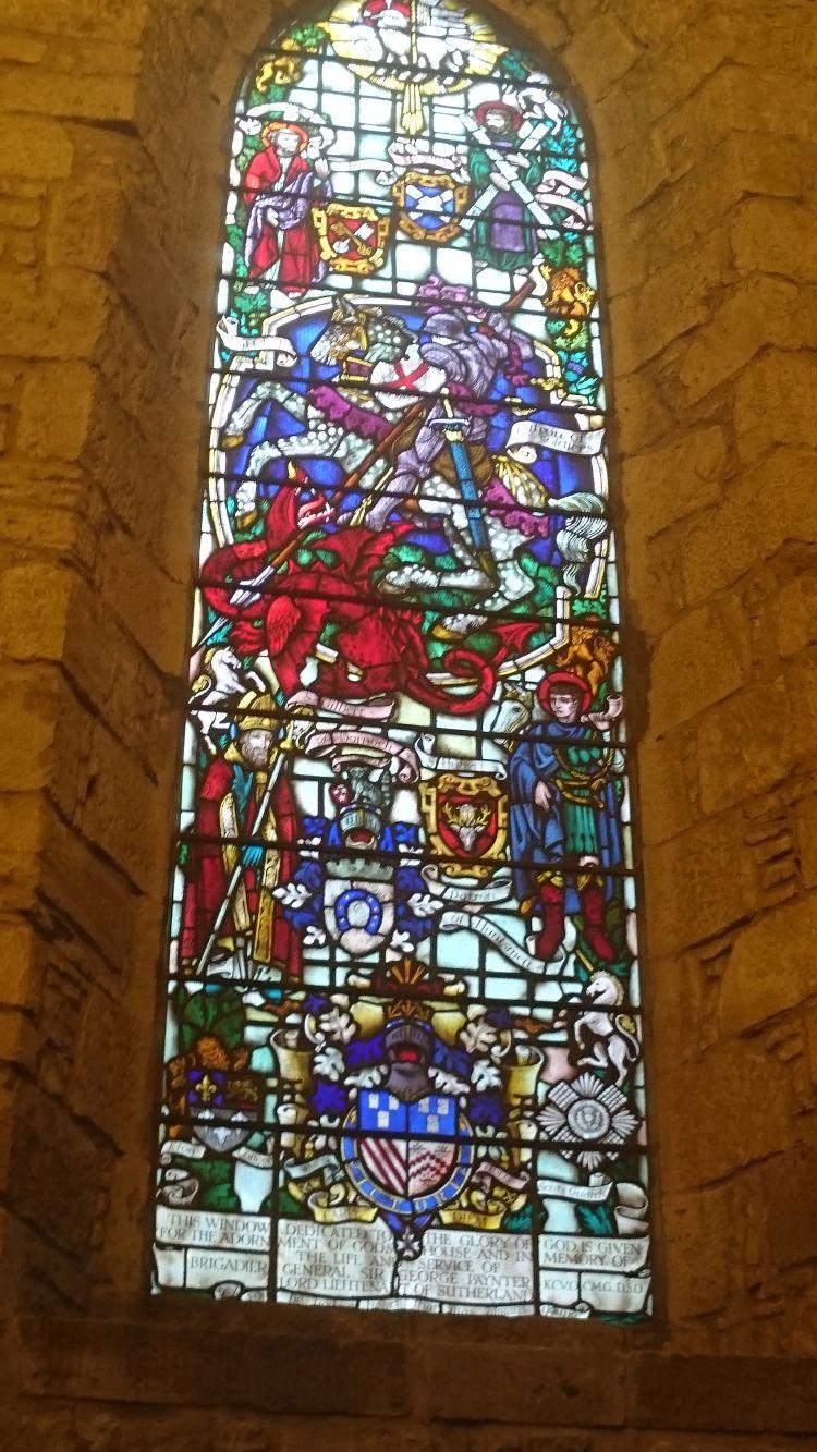 A tall stained glass window in the cathedral at Dornoch