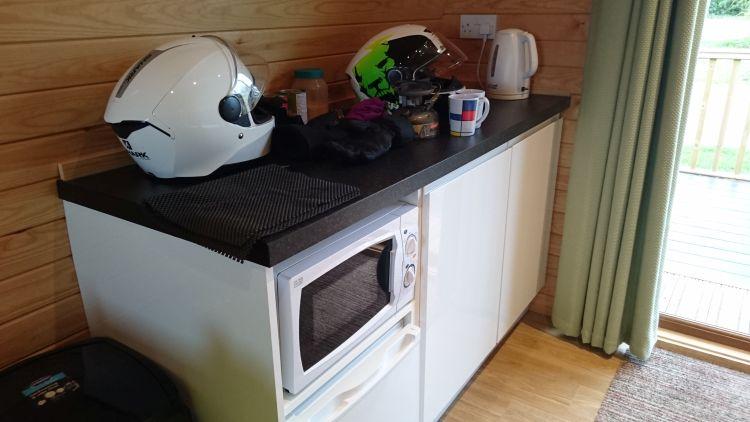 Inside the pod is a work surface and cupboard, kettle, microwave and basic kitchen utensils
