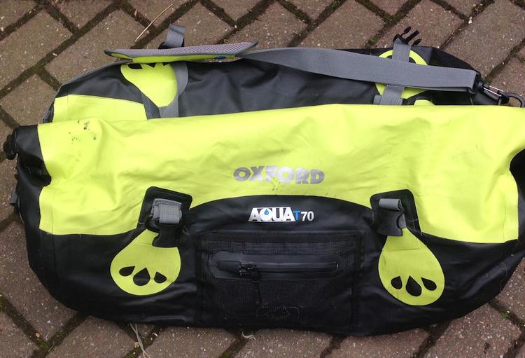 The large bright yellow Oxford roll bag complete with handles and straps