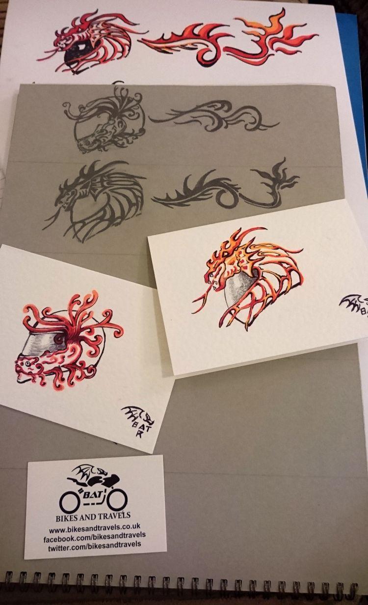 Various drawings of simple helmets with dragons and flames coming off them