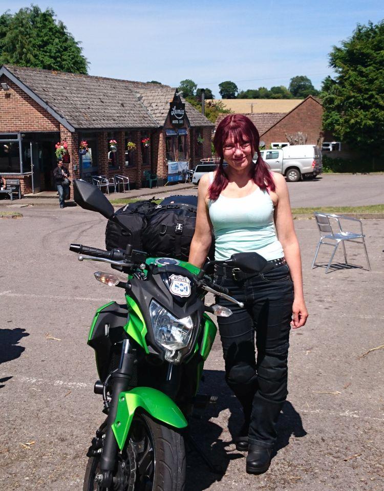 Sharon poses next to her bike wearing her snug fitting motorcycle jeans