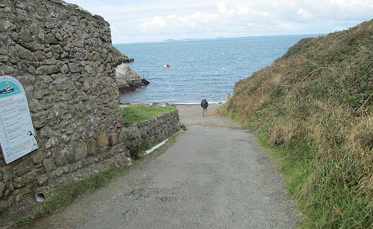 A steep narrow lane leads down to a tiny patch of shingle beach