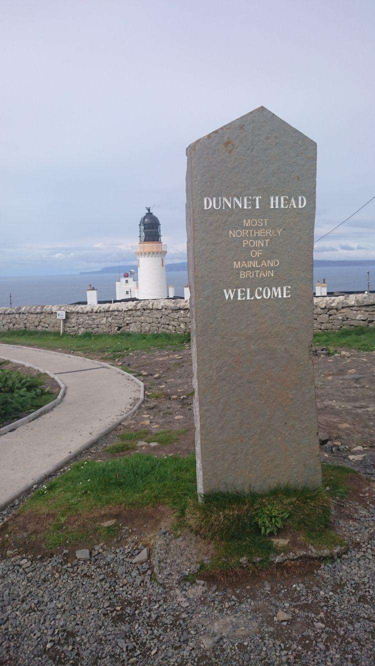 A smart clean stone with writing carved into it telling us we're at Dunnet Head