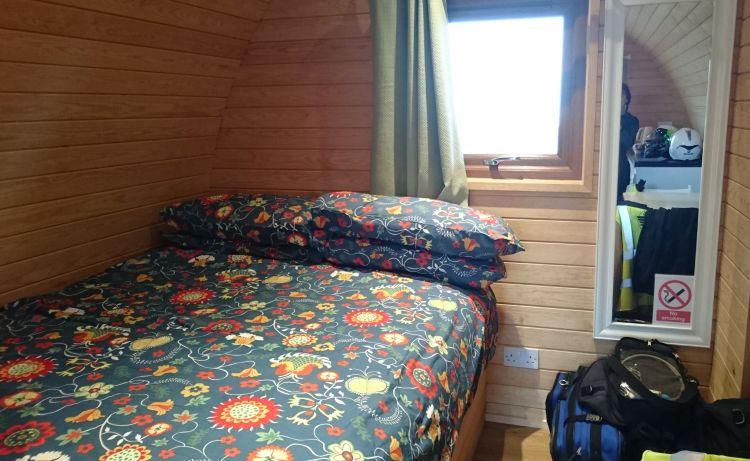 The double bed in the camping pod with duvet, sheets, pillow and warmth