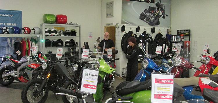 Sharon talks to Chas at the shop surrounded by bikes and bike kit