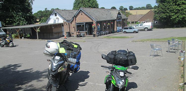 Loomies cafe, a brick building, a car park and some motorcycles in the sunshine