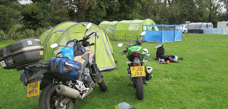The 2 motorcycles and the tent and kit at the campsite at Kiln Park, Tenby