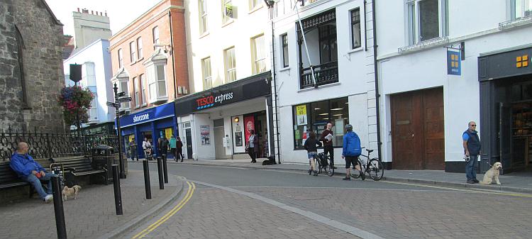 A Tesco and shoe shop squeezed into old buildings in Tenby town centre