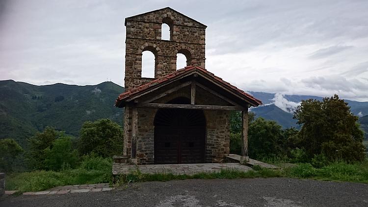 Side view of the tiny chapel with the Picos mountains behind