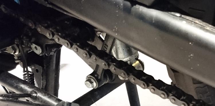 The rear suspension linage under the swingarm of the Enfield