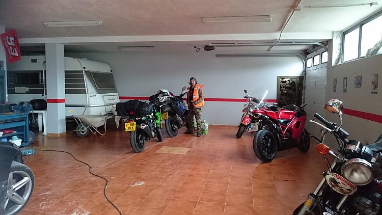 Inside is a large garage with a caravan, several motorcycles and a lot of space