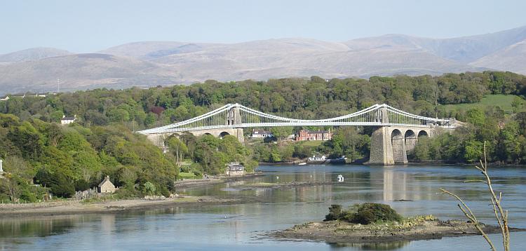 The Menai bridge across the straits. The Welsh mountains are hazy in the background