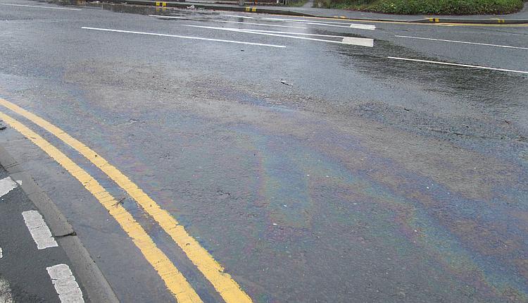 A rainbow of either oil or diesel at the junction of a road