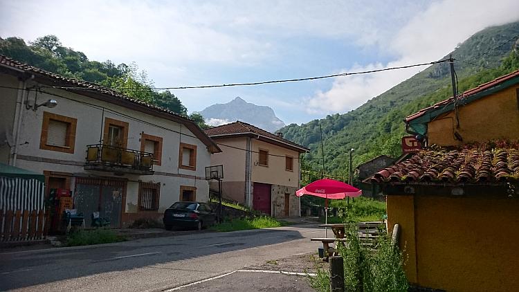 Old Spanish houses against towering mountains heading towards The Picos