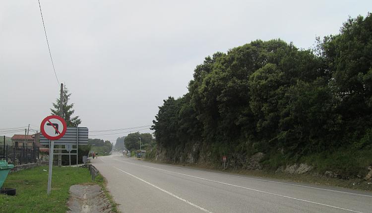An ordinary and plain road with heavy thick grey skies in La Franca, Spain
