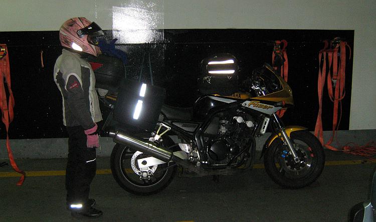 Sharon stands straight next to Ren's motorcycle on the Newhaven - Dieppe ferry