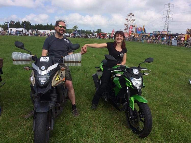 Sharon, Ren holding hands sat on their bikes at the Scorton Steam Fair
