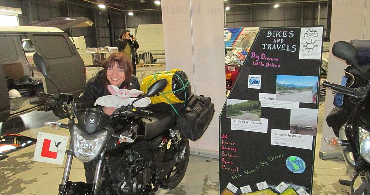 Sharon leans on her Keeway while setting up for the Manchester Bike Show in 2015