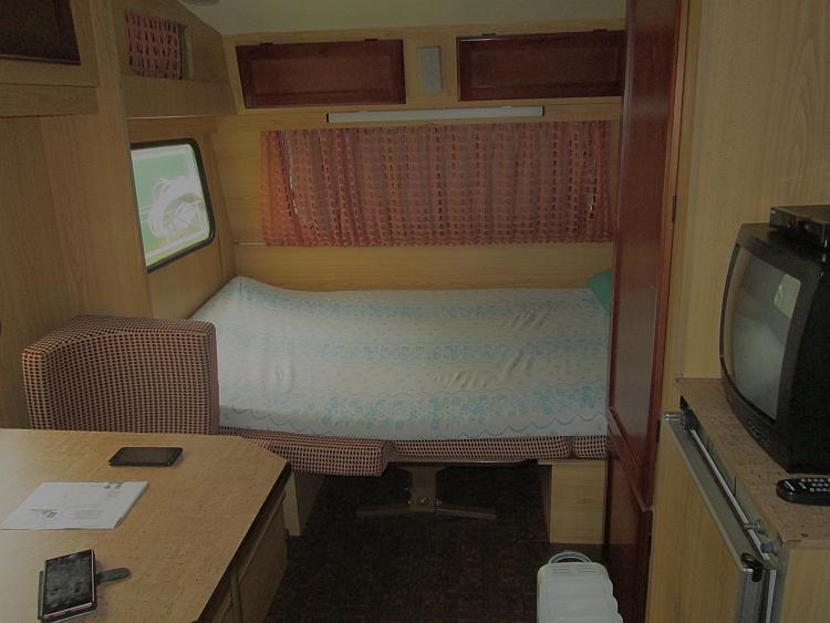 the inside of the small damp caravan