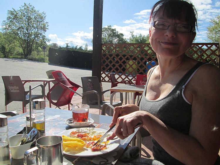 Sharon smiles in the glorious sun as she devours he delicious breakfast