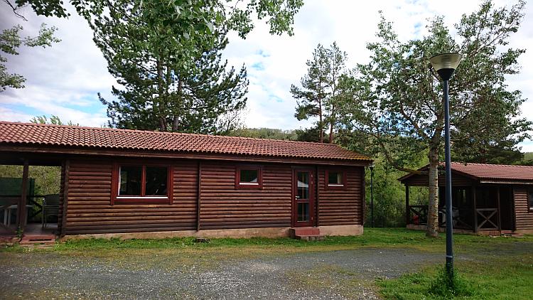 A wood log cabin or lodge at the campsite