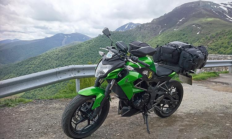 Sharons kawasaki z250sl with luggage against the stunning picos mountains