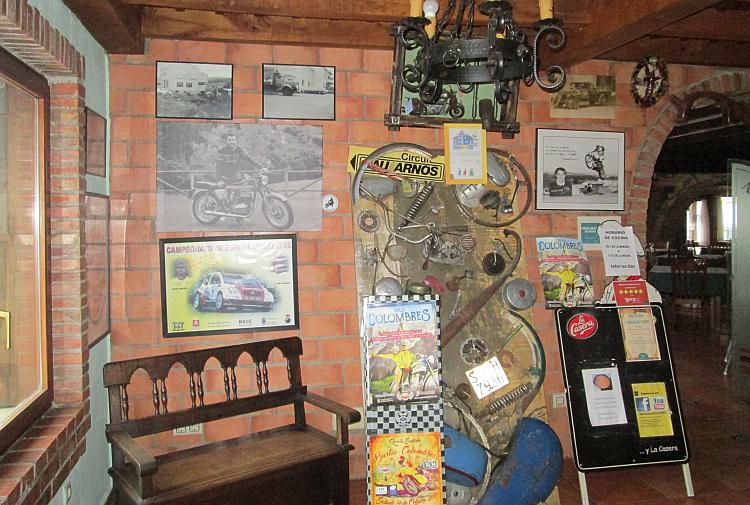 A collection of pictures and parts from motorsport on the wall of the hotel