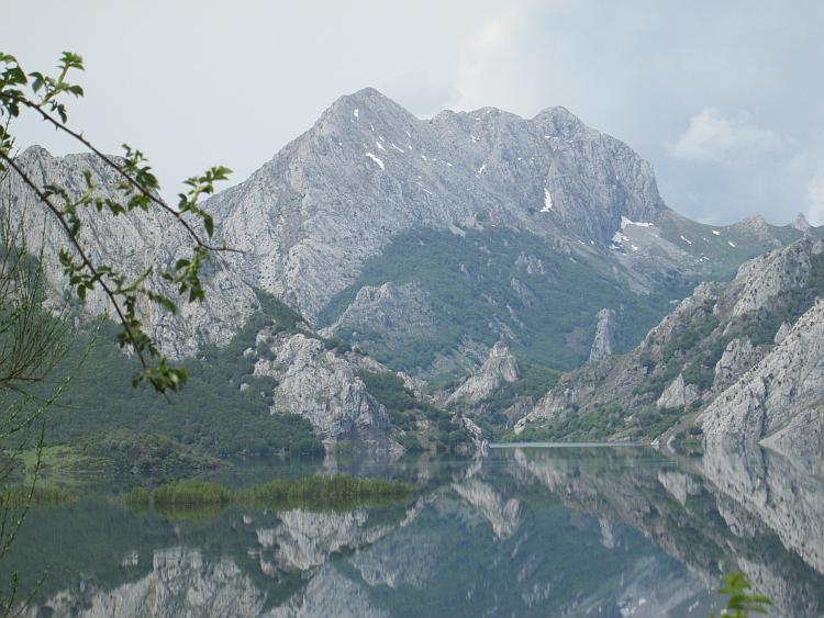 A beautiful rocky mountain in The Picos reflected on a lake