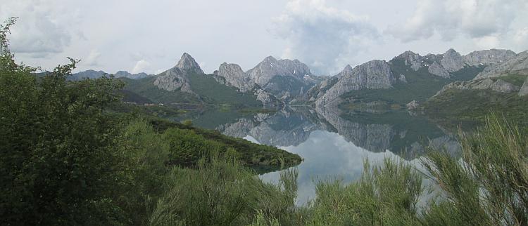The sharp rocky mountain tops are perfectly reflected in the waters