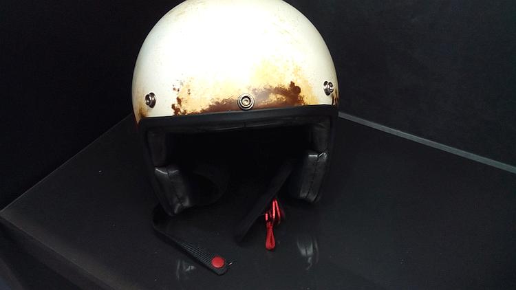 This open face helmet is painted to look like it's old, worn and dirty