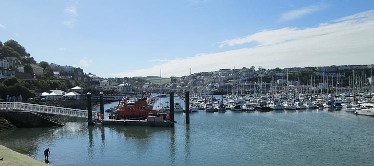 Brixham's harbour is large and filled with hundreds of boats, the town rises up from the bay