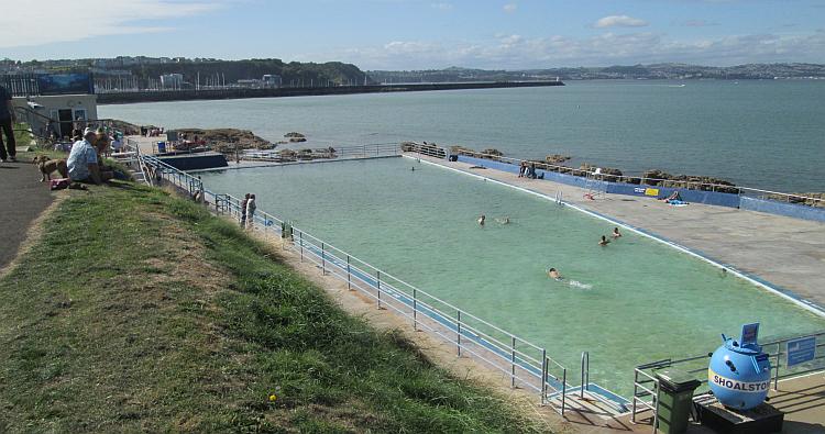 The turquiose waters of the Lido at Brixham look inviting on this warm day