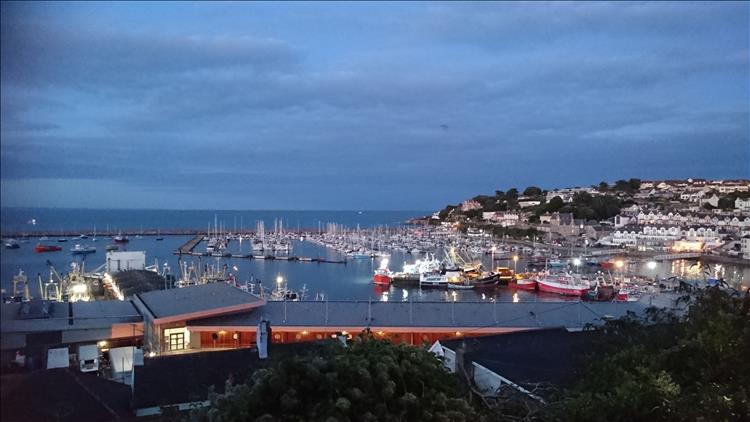 The lights on the harbour and the boats are starting to twinkle as the sun sets