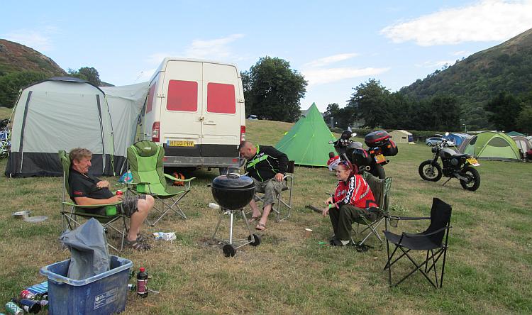 A few people in camping chair socialising at the Abbey farm campsite