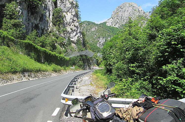 Steep rock faces, the road through the gorge and the nets to catch falling rocks