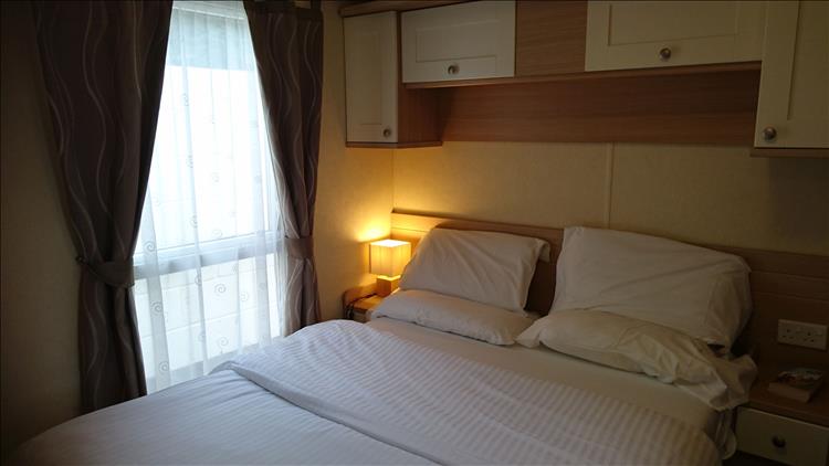 Within the caravan is a large comfortable double bed in a clean and pleasing room