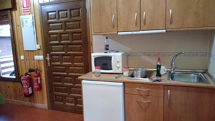 A small sink, microwave and cupbaords make the kitchen of the lodge