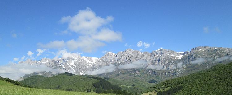 The rocky mountain peaks of The Picos De Europa in glorious sun and light cloud