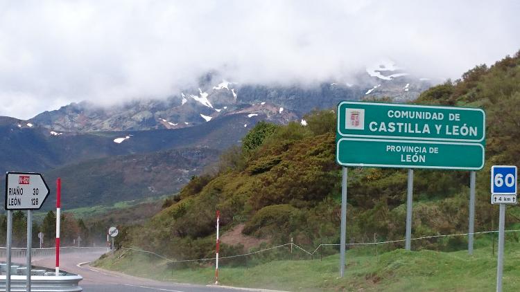 The border sign in the misty Picos mountains at Puerto de San Glorio