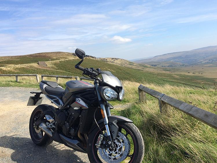Latchy's gorgeous street triple with new tyres against some equally gorgeous countryside