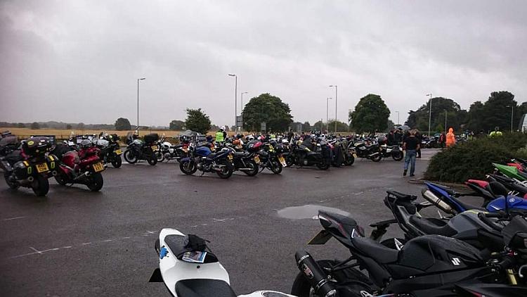 The car park is wet, the skies are grey and the motorcycles look forlorn in the horrible weather