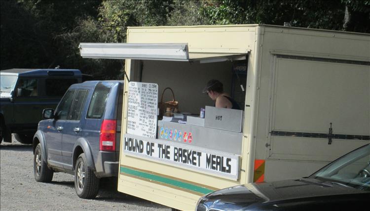 A food van with a sign on the front stating hound of the basket meals at hound tor