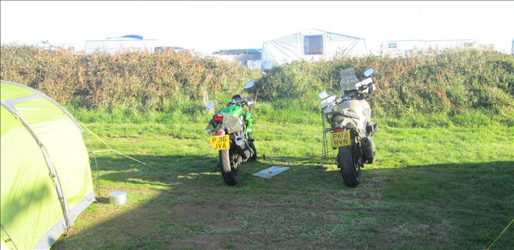 2 motorcycles and a tent in the low morning sun at Shell Island's campsite