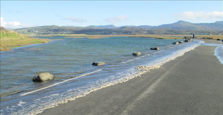 The sea water is just barely covering the edge of the road from the campsite to the mainland