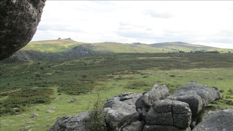 Looking out from the tor we see rolling hills with rocky outcrops stretching to the distance