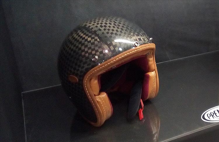 A carbon look helmet made in a traditional vintage style