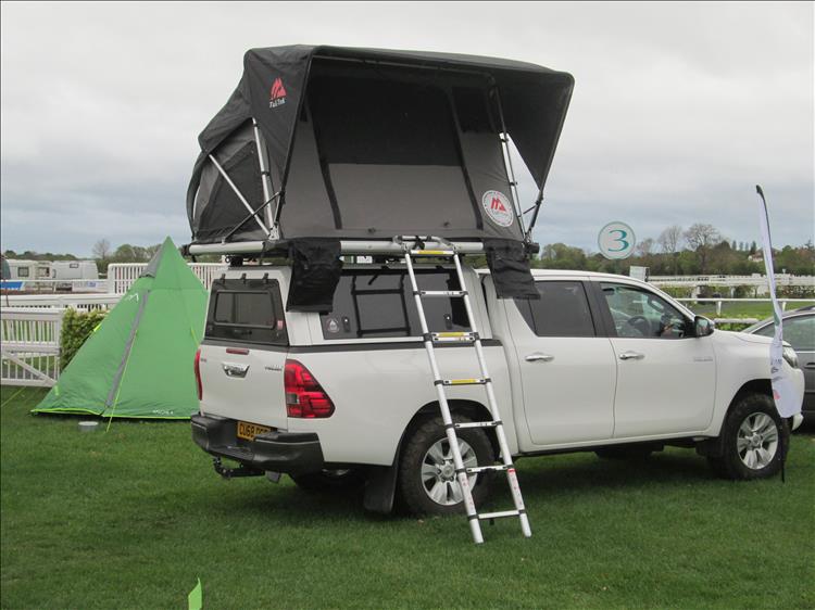 Toyota Hilux with roof tent, Ren's small teepee tent is hiding behind the adventure car
